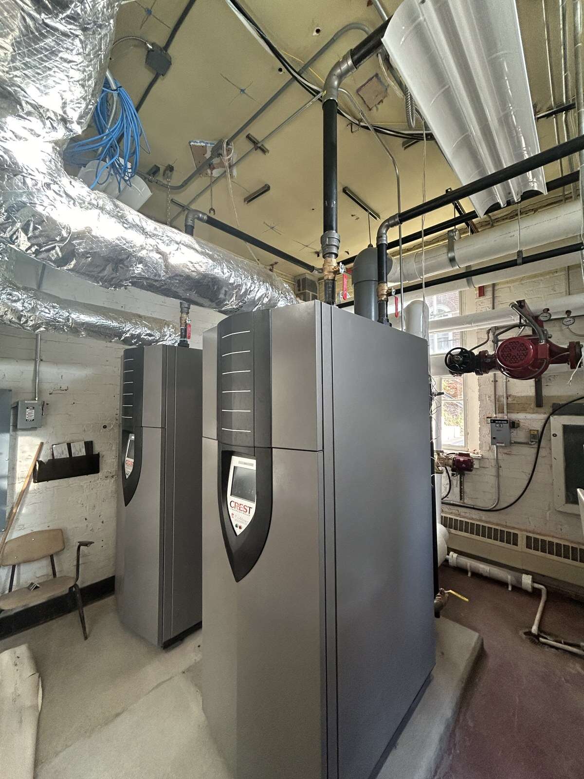 Commercial boilers and water heaters in a mechanical room installed by Young's Mechanical — mechanical room, boiler, water heater