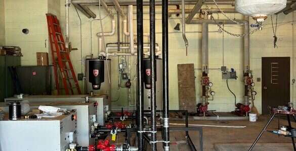 Commercial mechanical room piping and tanks installed by Young's Mechanical Solutions — mechanical room, piping