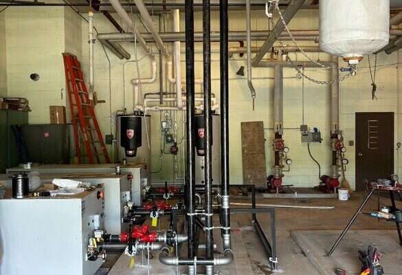 Commercial mechanical room piping and tanks installed by Young's Mechanical Solutions — mechanical room, piping