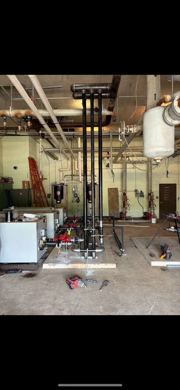 Commercial mechanical room piping and tanks installed by Young's Mechanical Solutions — mechanical room, piping