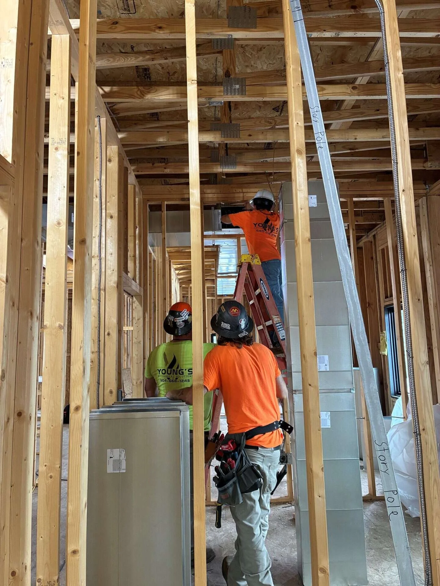 Young's Mechanical Solutions sheet metal crew installing commercial ductwork on a Bridgewater, Virginia job site
