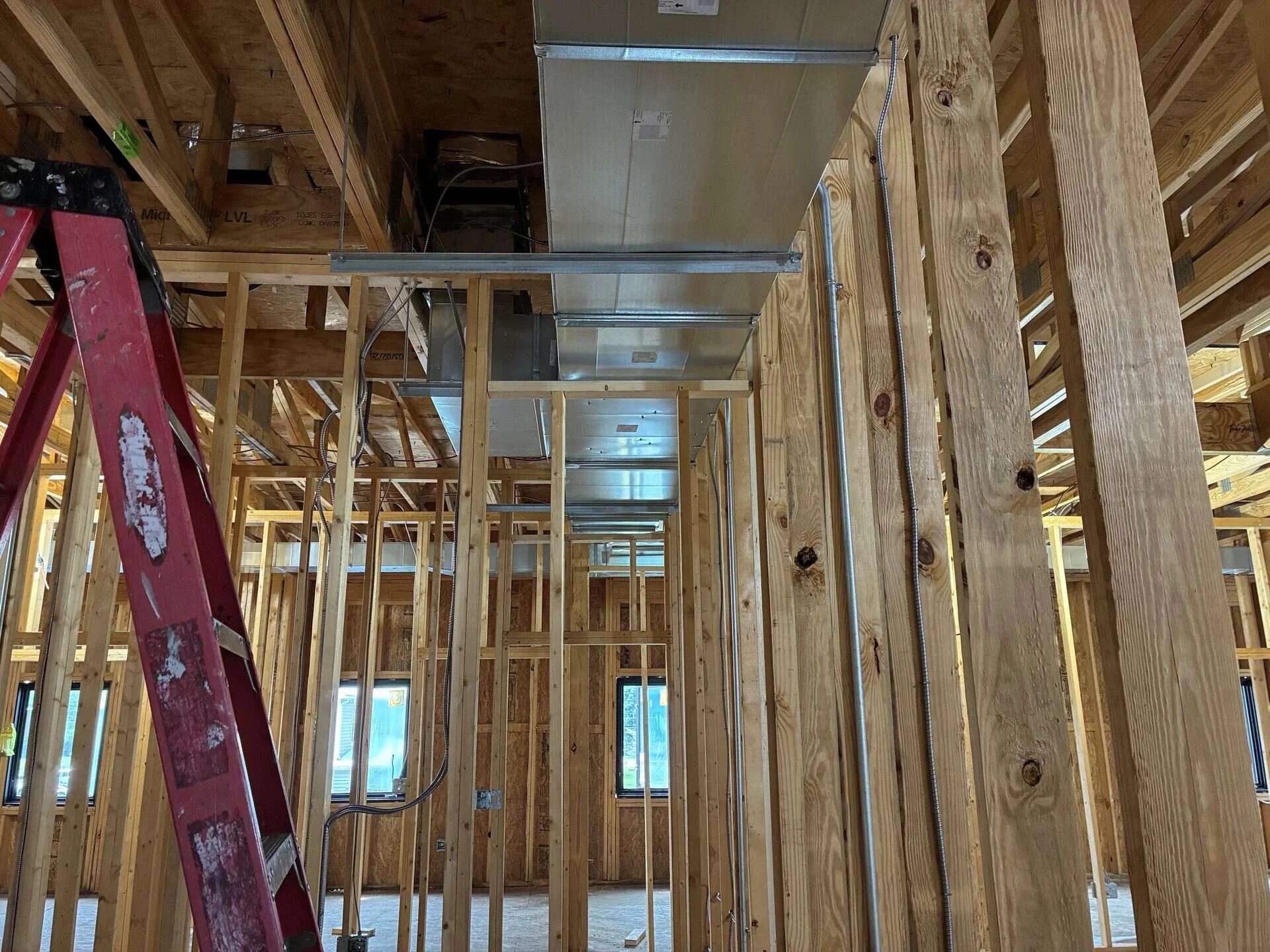 Long run of rectangular supply ductwork installed through wood framing in a commercial building