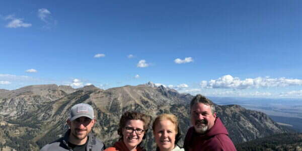 Young's Mechanical Solutions team member Mark Dean and family at a mountain overlook in the Grand Tetons, Wyoming