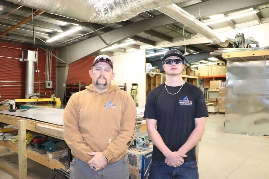 Two Young's Mechanical Solutions service technicians in the company shop in Harrisonburg