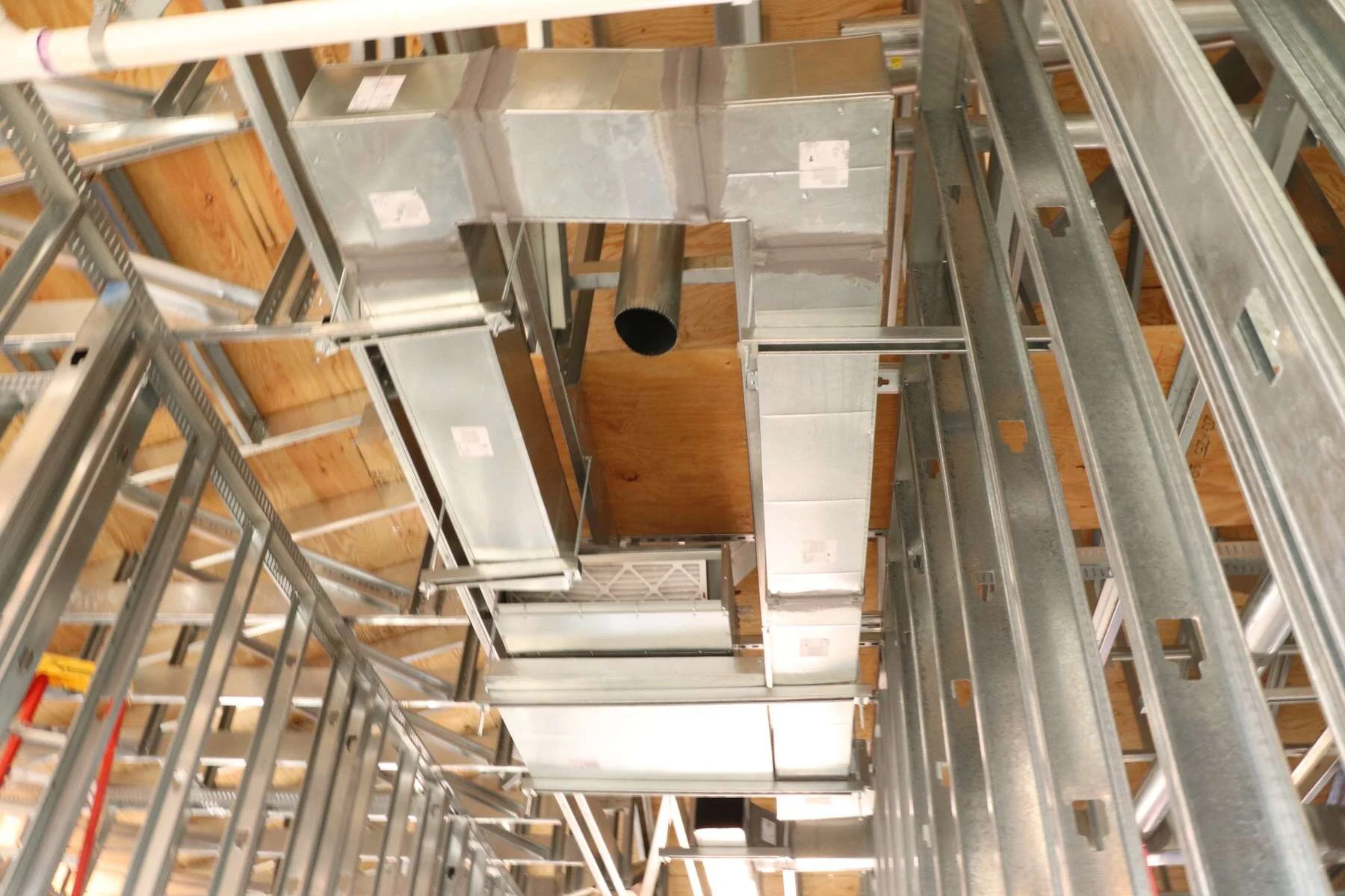Galvanized supply ductwork and terminal units installed overhead in a commercial office building by Young's Mechanical Solutions