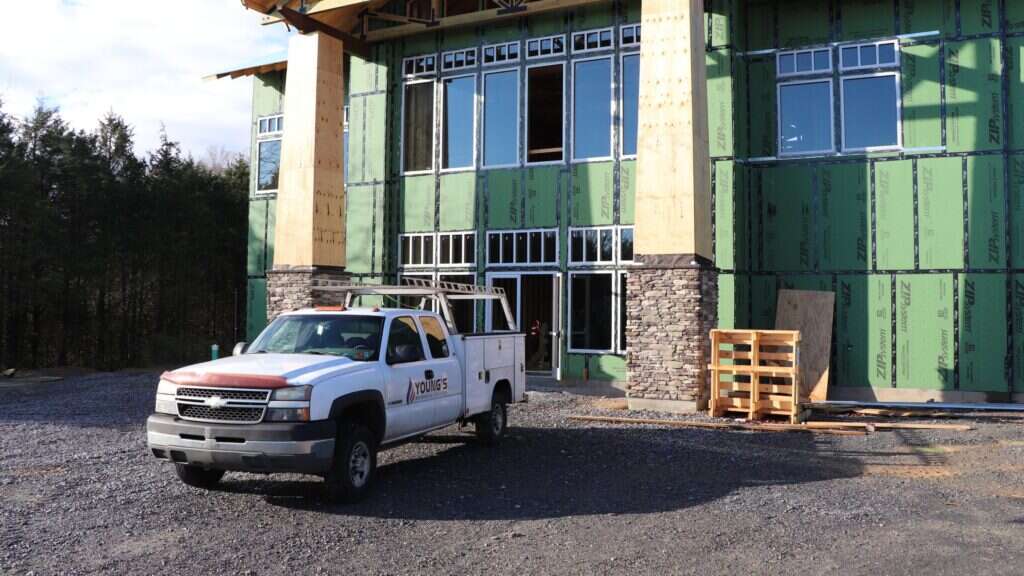 Young's Mechanical Solutions service truck parked at a commercial building under construction in the Shenandoah Valley