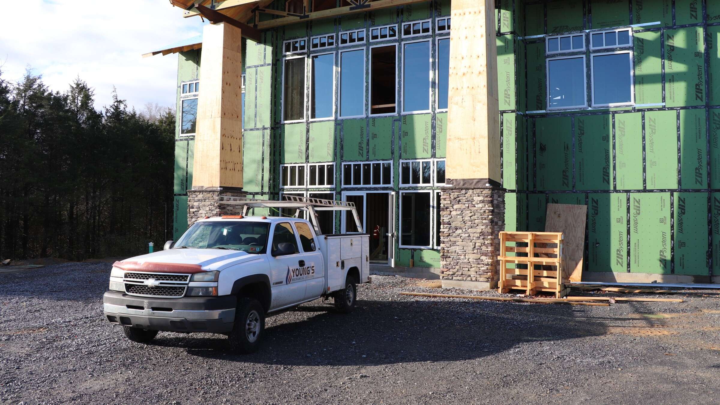 Young's Mechanical Solutions service truck parked at a commercial building under construction in the Shenandoah Valley